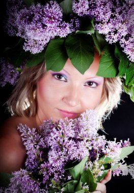 Girl with a sweet bouquet of lilacs clipart