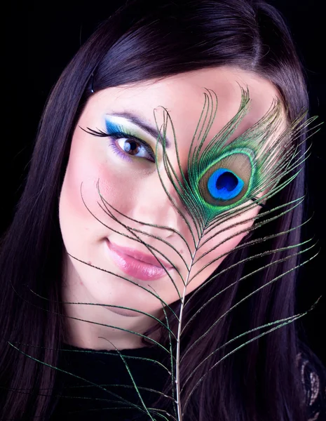 stock image Girl with peacock feathers