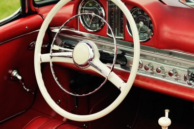 Dashboard and steering wheel of collectors car clipart