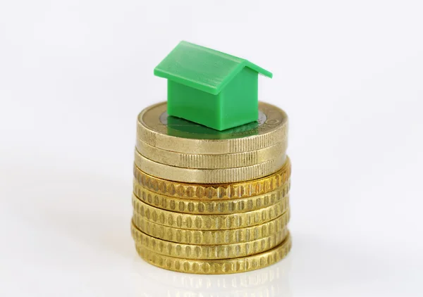 Coins and model house — Stock Photo, Image