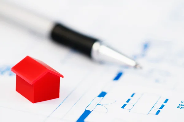 stock image Red model house with architecture plan and pen