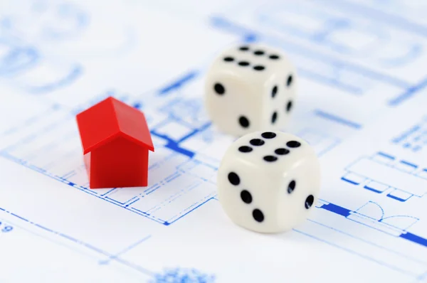 Red model house with architecture plan and dices — Stock Photo, Image