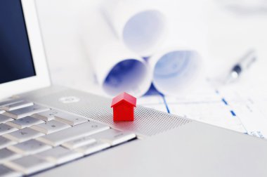 Red model house and laptop clipart