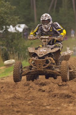 Quad Racer on the muddy track clipart