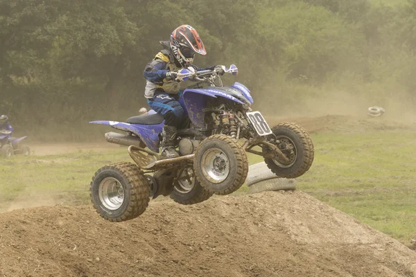 Very young boy jumps a Quad motobike in the race — Stock Photo, Image