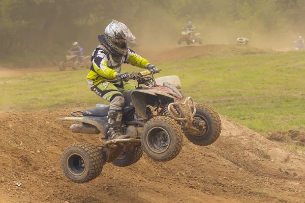Boy jumping on the quad during the race — Stock Photo, Image