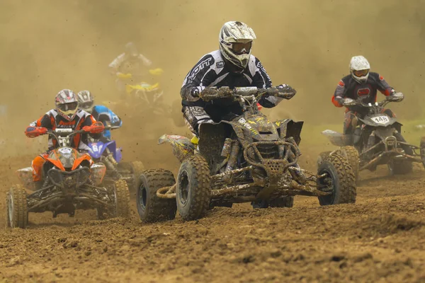 Group Quad motorbike racers in the dust shrouded — Stock Photo, Image