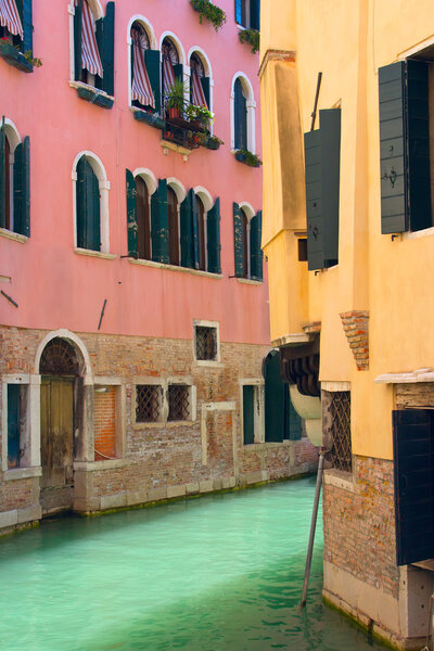 View of Canal in Venice with pink and yellow house (Venice, Italy)