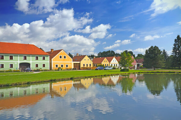 Rural decorated houses in Zabori ( Czech Republic) UNESCO World Heritage Site in South Bohemia. In the foreground is the village pond.