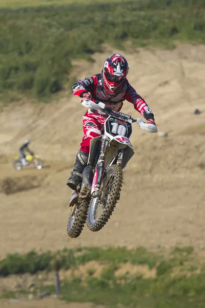 Motorbike rader in red jumps. — Stock Photo, Image