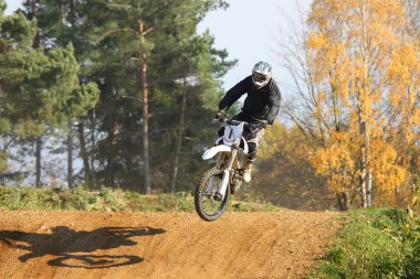 Motocross rider jumps (nice shadow) clipart