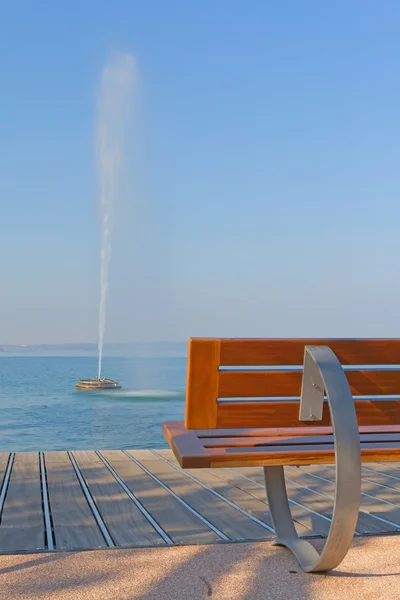 stock image Modern bench and fontain in the lake