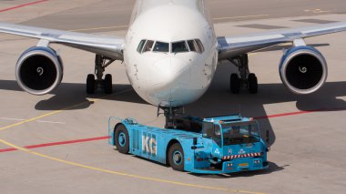 Delta Boeing 737 is pulled by a special tow car clipart