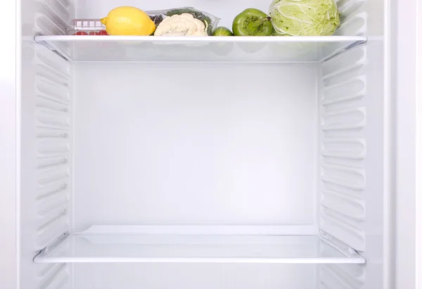 Refrigerador medio vacío Imágenes de stock libres de derechos