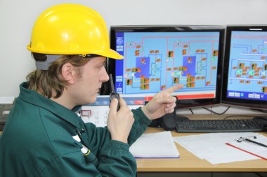 Industrial worker in control room clipart