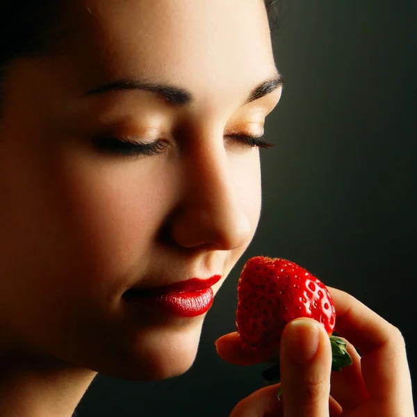 stock image Woman smelling strawberry