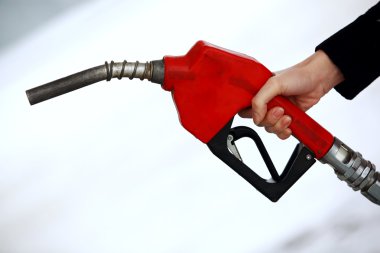 Gas nozzle in woman's hand clipart