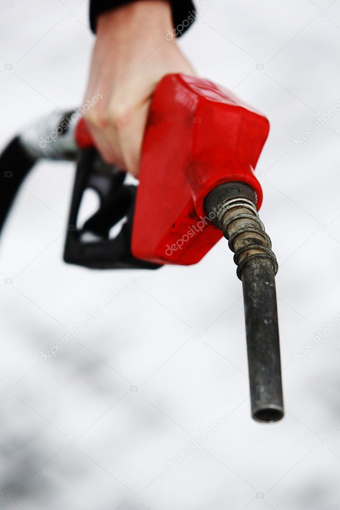 Gas nozzle in woman's hand