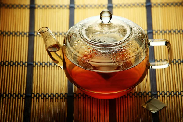 Glass teapot with teabag inside — Stock Photo, Image
