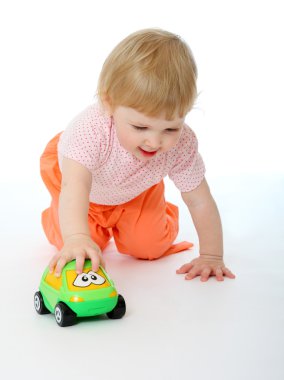 Baby playing with a toy car clipart