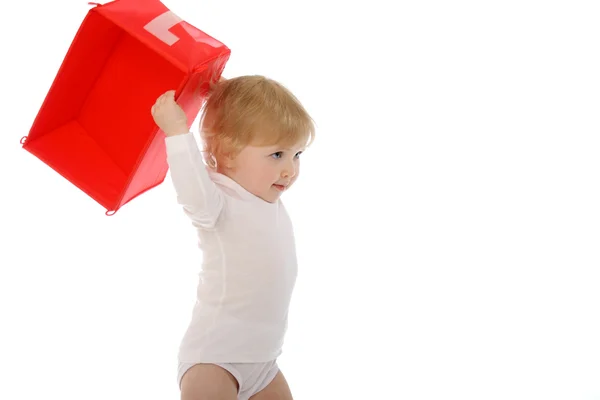 Baby throwing red box isolated on white — Stock Photo, Image