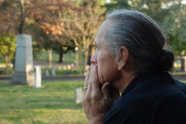 Man sitting at gravesite clipart