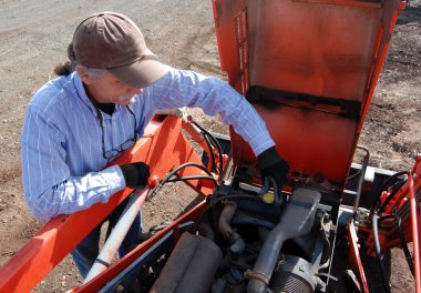 Removing radiator cap on tractor clipart