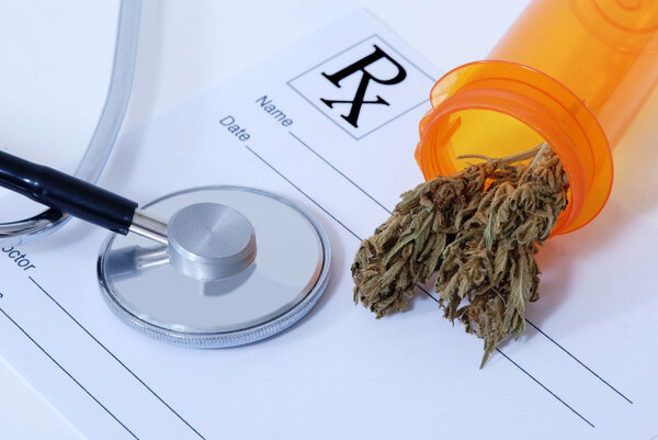 Cannabis bud near medical items
