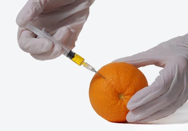Orange with hypodermic needle — Stock Photo, Image