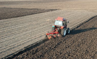 Tractor Plowing in sunset clipart