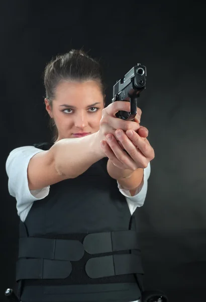 Young woman with a gun — Stock Photo, Image