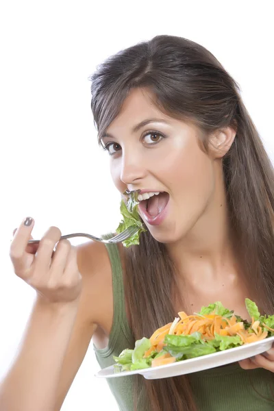 Mladý bělošský bruneta jíst zeleniny izolovaných na bílém — Stock fotografie