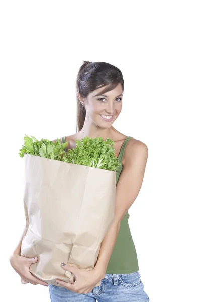 Mladý bělošský bruneta hloding sáček zeleniny — Stock fotografie