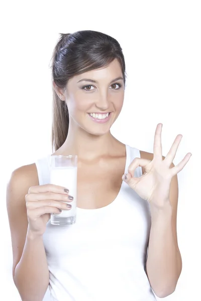 stock image Young caucasian brunette holding a glass of milk isolated on whi