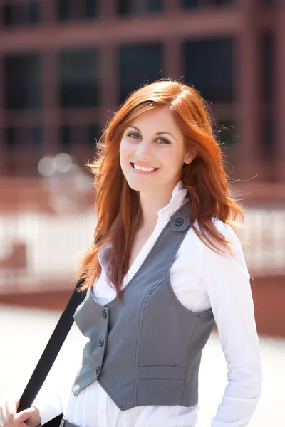 Young adult businesswoman smiling outdoors — Stock Photo, Image