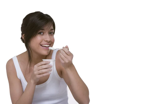 stock image Young caucasian brunette eating yogurt.Room to insert text