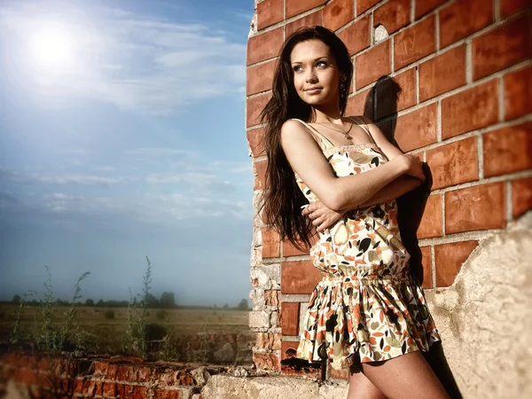 Attractive girl near the brick wall Royalty Free Stock Images