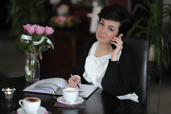 stock image Busy businesswoman with phone and calendar