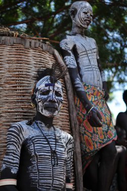 Chief of the Karo with a boy in the background clipart