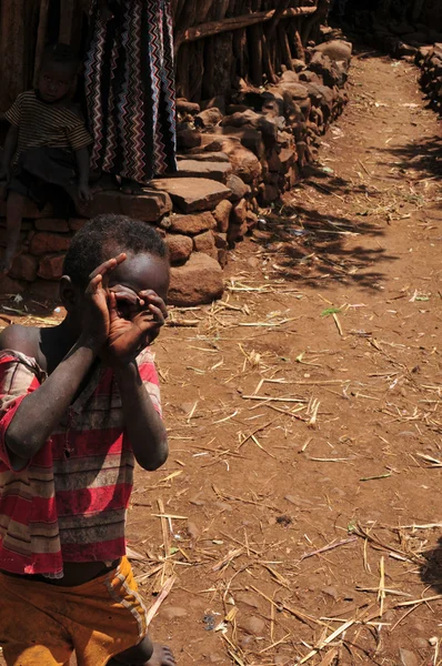 Little boy in an ethiopian village — Stock Photo, Image