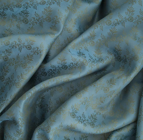 Синий шелк с цветочным орнаментом — стоковое фото