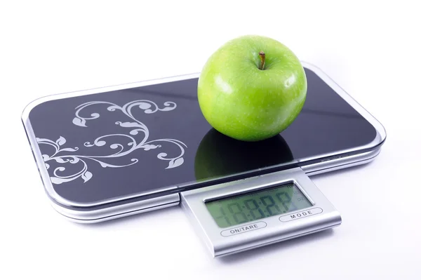 Apple on the scales — Stock Photo, Image