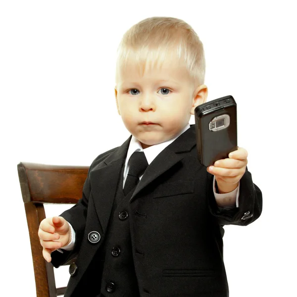 The boy in a suit has control over phone — Stock Photo, Image