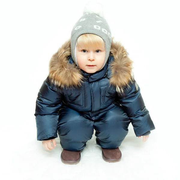 stock image The boy in winter overalls