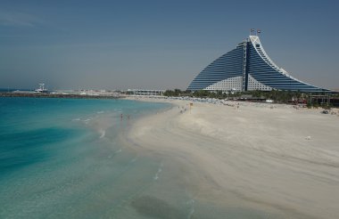 Jumeirah Beach hotel overlooking the beach clipart