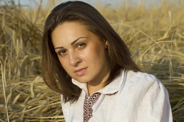 Portret van een jonge vrouw op een veld — Stockfoto