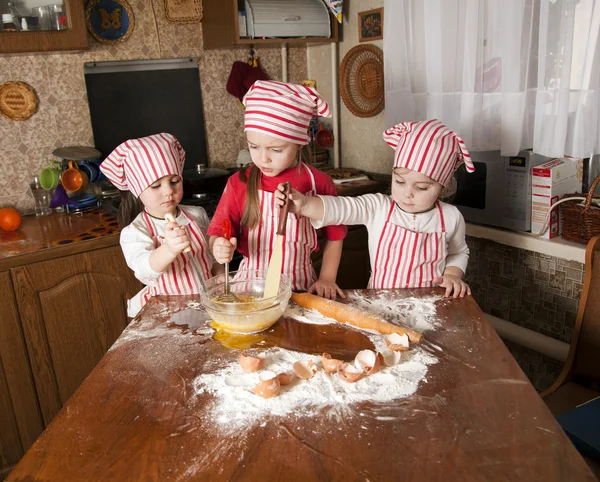 Three little chefs enjoying in the kitchen making big mess. Litt — Stock Photo, Image