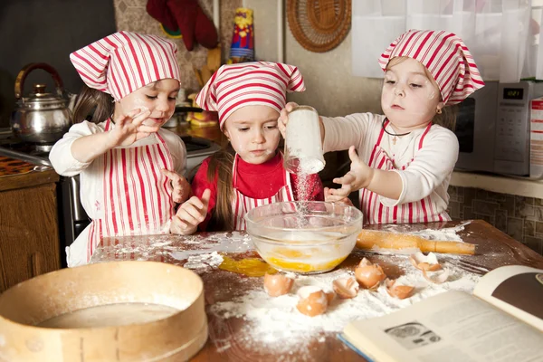 stock image Three little chefs enjoying in the kitchen making big mess. Litt