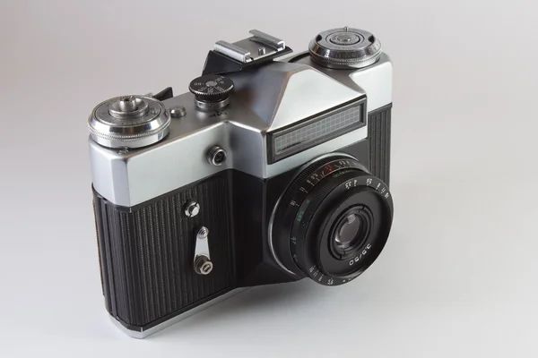 stock image Old SLR film camera on grey background