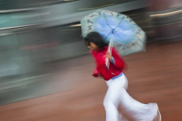 Girl running with umbrella — Stock Photo, Image